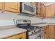 Kitchen with stainless steel microwave and gas range at 41512 N Tangle Ridge Ct, Anthem, AZ 85086