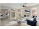 Bright living room with white sofa, open design, and view of the dining area at 41512 N Tangle Ridge Ct, Anthem, AZ 85086