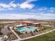 Aerial view of a community center with pools, a water slide, and parking at 44049 W Palo Nuez St, Maricopa, AZ 85138