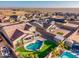 Aerial view of the house, neighborhood and backyard pool at 44049 W Palo Nuez St, Maricopa, AZ 85138
