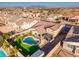 Aerial view of a house with a pool and a backyard, surrounded by other houses and landscape at 44049 W Palo Nuez St, Maricopa, AZ 85138