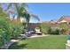 Landscaped backyard with seating area and lush greenery at 44049 W Palo Nuez St, Maricopa, AZ 85138