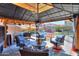 Relaxing backyard patio with covered seating area, and a view of the pool at 44049 W Palo Nuez St, Maricopa, AZ 85138