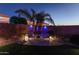 Private backyard patio with seating area, surrounded by lush landscaping, offering a serene retreat at 44049 W Palo Nuez St, Maricopa, AZ 85138