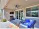 Covered patio with comfortable seating, a TV, and a view of the backyard pool at 44049 W Palo Nuez St, Maricopa, AZ 85138