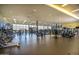 Modern fitness center with various exercise equipment and large windows at 44049 W Palo Nuez St, Maricopa, AZ 85138