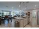 Open concept kitchen with breakfast bar, island and Gathering room views at 44049 W Palo Nuez St, Maricopa, AZ 85138
