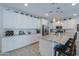 Modern kitchen featuring granite countertops and white cabinetry at 44049 W Palo Nuez St, Maricopa, AZ 85138