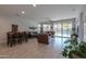 Open living room with tile floors, sliding glass doors, and a pool view at 44049 W Palo Nuez St, Maricopa, AZ 85138