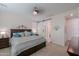 Spacious main bedroom with a barn door, large bed, and ensuite bathroom at 44049 W Palo Nuez St, Maricopa, AZ 85138