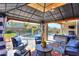 Covered patio with comfortable seating overlooking the pool and backyard at 44049 W Palo Nuez St, Maricopa, AZ 85138