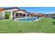 Stunning kidney shaped pool with a large grassy backyard at 44049 W Palo Nuez St, Maricopa, AZ 85138