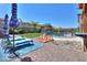Inviting pool area with lounge chairs and a Japanese bridge at 44049 W Palo Nuez St, Maricopa, AZ 85138