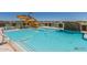 Community pool with a waterslide and lounge chairs at 44049 W Palo Nuez St, Maricopa, AZ 85138