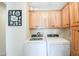 Laundry room with washer, dryer and wood cabinets at 5735 E Mcdowell Rd # 306, Mesa, AZ 85215