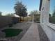 Landscaped backyard with a covered patio and artificial turf at 5822 E Bramble Berry Ln, Cave Creek, AZ 85331