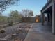 Landscaped backyard with patio and pathway lighting at 5822 E Bramble Berry Ln, Cave Creek, AZ 85331