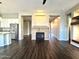 Open living area with hardwood floors, a fireplace, and kitchen views at 5822 E Bramble Berry Ln, Cave Creek, AZ 85331