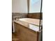 Relaxing soaking tub with granite surround and tile accents at 5822 E Bramble Berry Ln, Cave Creek, AZ 85331