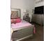 Charming bedroom featuring a bed, nightstand, and large dresser at 5954 W Townley Ave, Glendale, AZ 85302