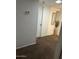 Well-lit hallway with light colored walls and carpet at 5954 W Townley Ave, Glendale, AZ 85302