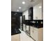 Modern kitchen with white cabinets, granite counters, and stainless steel appliances at 5954 W Townley Ave, Glendale, AZ 85302