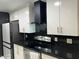 Modern kitchen with black granite countertops and stainless steel appliances at 5954 W Townley Ave, Glendale, AZ 85302