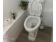 Clean toilet in the small bathroom with neutral decor at 5954 W Townley Ave, Glendale, AZ 85302