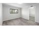 Spacious bedroom featuring wood-look tile floors and a large window at 6121 E Vernon Ave, Scottsdale, AZ 85257