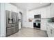 Modern kitchen with stainless steel appliances and white cabinets at 6321 N Oro Vista Ct, Litchfield Park, AZ 85340