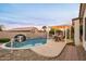 Inviting kidney shaped pool with pergola and patio furniture at 6321 N Oro Vista Ct, Litchfield Park, AZ 85340