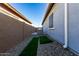 Private backyard with artificial turf, gravel, and built-in grill at 640 S Olympic Dr, Gilbert, AZ 85296