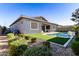 Landscaped backyard featuring a pool and patio area at 640 S Olympic Dr, Gilbert, AZ 85296