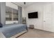 Bedroom with large window and wall-mounted TV at 640 S Olympic Dr, Gilbert, AZ 85296
