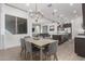 Open concept dining area with kitchen view and wood table at 640 S Olympic Dr, Gilbert, AZ 85296