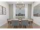 Elegant dining room with a large wood table and chandelier at 640 S Olympic Dr, Gilbert, AZ 85296