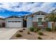 Two-car garage, stone accents, and landscaped front yard at 640 S Olympic Dr, Gilbert, AZ 85296