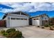 Two-car garage, stone accents, and well-maintained landscaping at 640 S Olympic Dr, Gilbert, AZ 85296