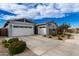 Two-car garage, stone accents, and nicely landscaped yard at 640 S Olympic Dr, Gilbert, AZ 85296