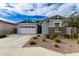 Single-story home with two-car garage, stone accents, and landscaped yard at 640 S Olympic Dr, Gilbert, AZ 85296