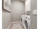 Laundry room with white washer and dryer at 640 S Olympic Dr, Gilbert, AZ 85296