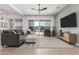 Spacious living room with large TV, pool view, and comfortable seating at 640 S Olympic Dr, Gilbert, AZ 85296