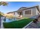 Inviting backyard pool with grassy area and stone feature at 640 S Olympic Dr, Gilbert, AZ 85296
