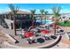 Community pool and patio area with tables and umbrellas at 650 N Hawes Rd # 3702, Mesa, AZ 85207