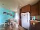 Kitchen features wood cabinets, white appliances, and a sunny window at 650 N Hawes Rd # 3702, Mesa, AZ 85207