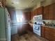 Galley kitchen with wood cabinets and modern appliances at 650 N Hawes Rd # 3702, Mesa, AZ 85207