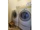 Laundry room with side-by-side washer and dryer, and a wooden step stool at 650 N Hawes Rd # 3702, Mesa, AZ 85207