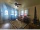 Bright living room featuring wood floors and a ceiling fan at 650 N Hawes Rd # 3702, Mesa, AZ 85207