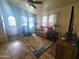 Bright living room featuring wood floors and a ceiling fan at 650 N Hawes Rd # 3702, Mesa, AZ 85207