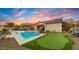 Luxury home with a putting green, pool, and spacious backyard at 6697 S Banning St, Gilbert, AZ 85298